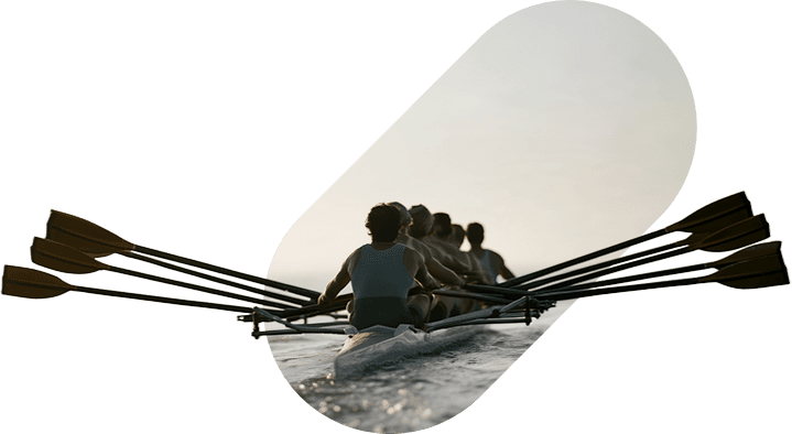 A rowing eight pulling together at dawn.